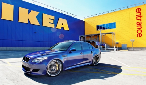 The picture features a blue BMW E60 M5 parked in front of a local IKEA store